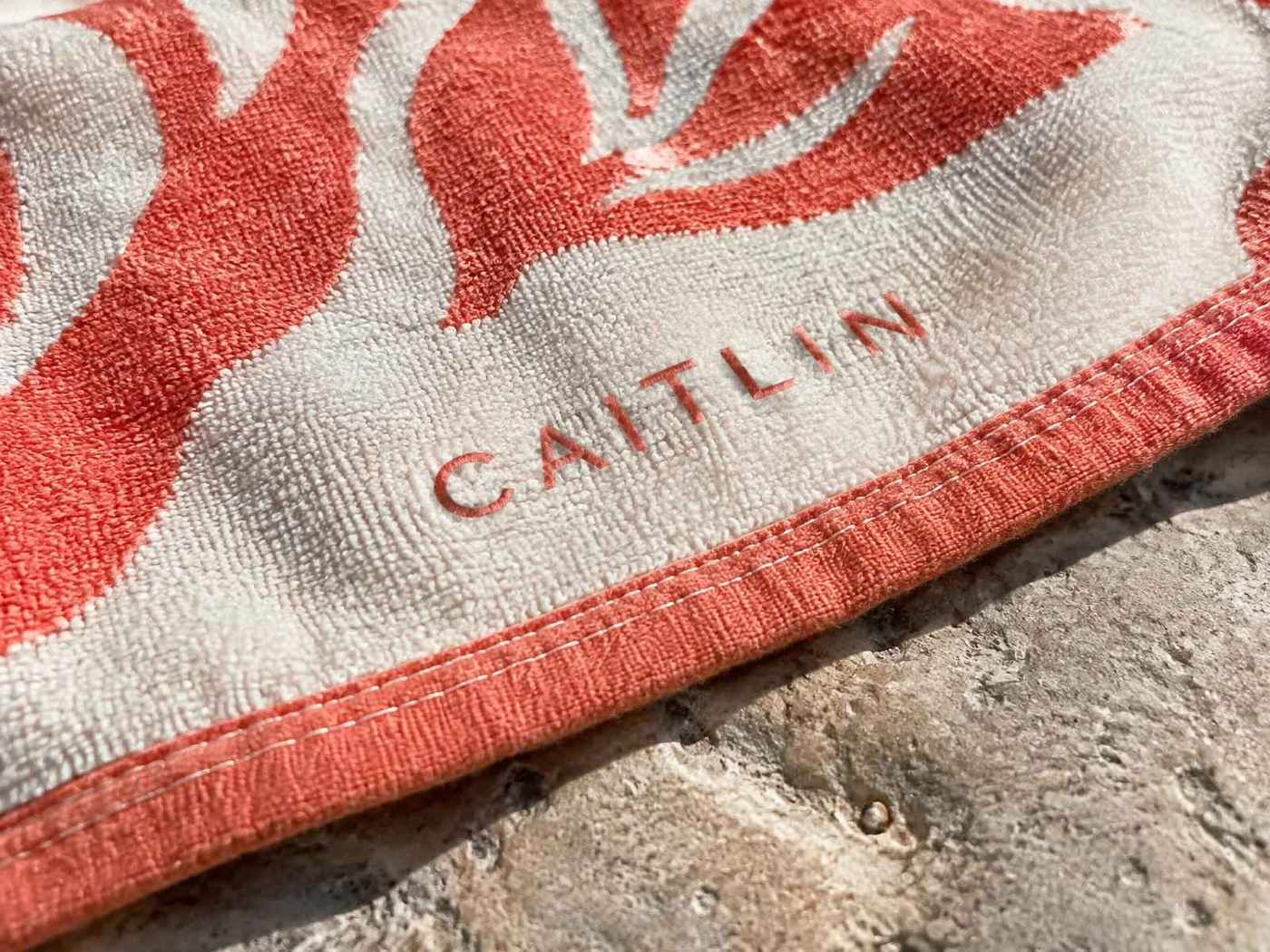 Close-up of printed artwork and the stitched hem on a personalized beach towel