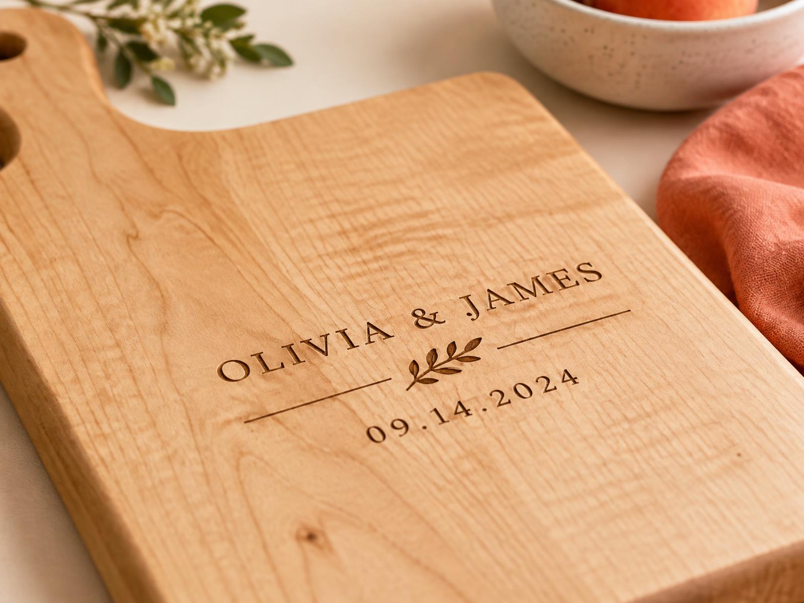 Macro close-up of a laser-engraved name and wedding date on a maple cutting board