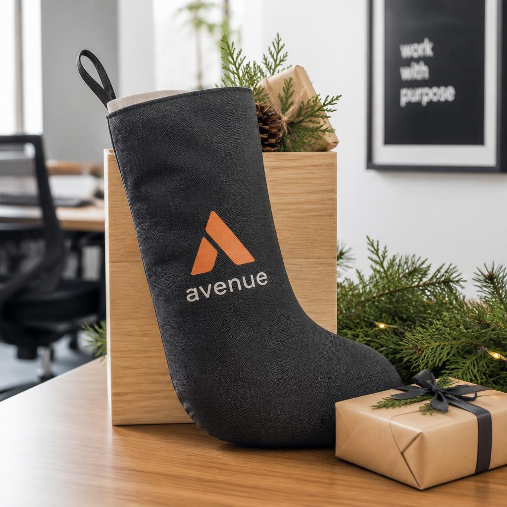 Branded corporate Christmas stocking in charcoal canvas with a printed company logo, styled on a modern desk