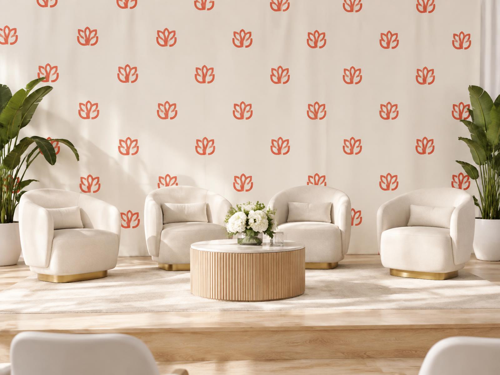 Large custom printed backdrop with a coral and cream logo pattern behind a stage setup